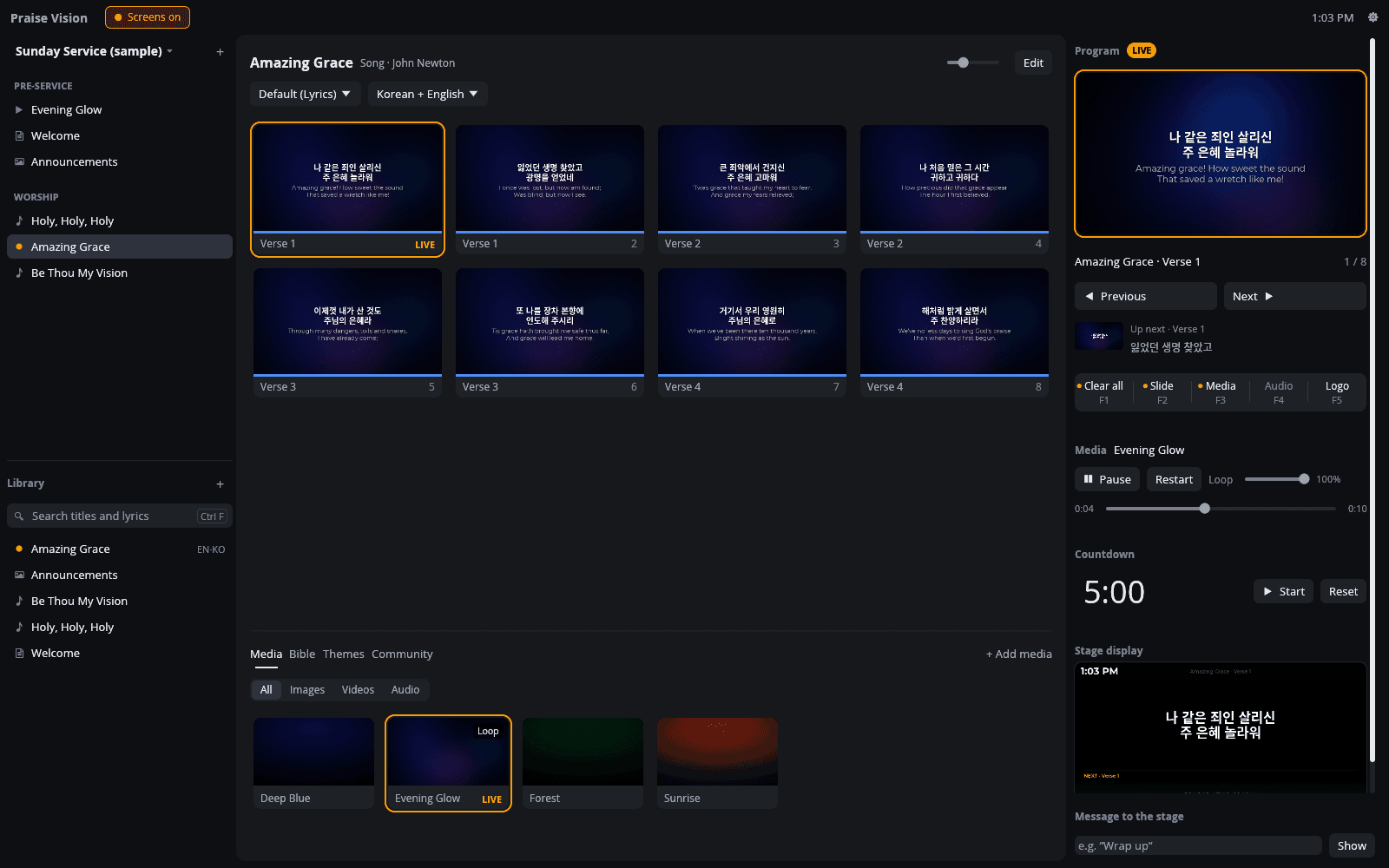 The Praise Vision operator window during a service: the playlist and library on the left, the slides of Amazing Grace in Korean and English in the middle with the first slide live, and the program preview, show controls, countdown and stage display preview on the right.